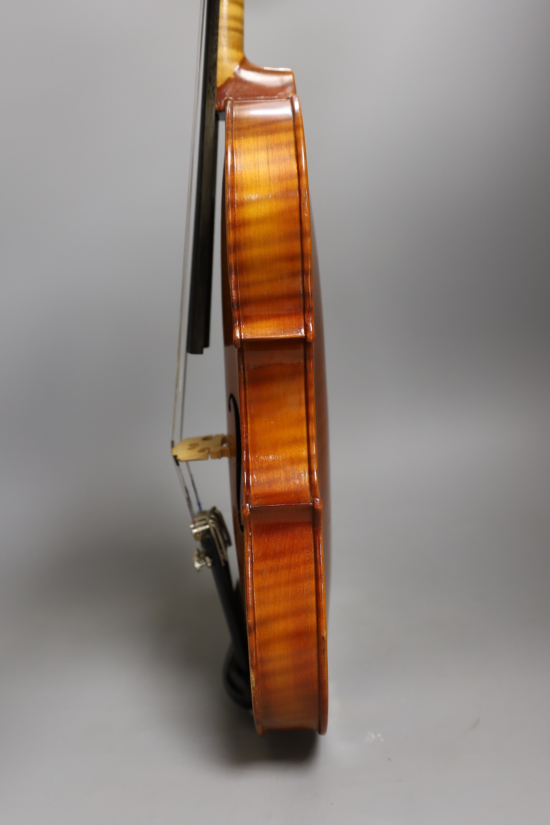 A cased child's violin and bow with ivorine tip, violin 55cms long